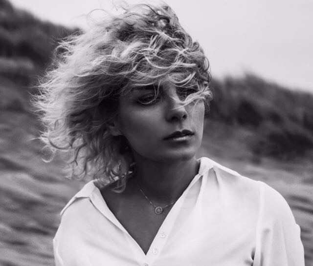 Black and white portrait of Mobina Nouri with wind-blown hair