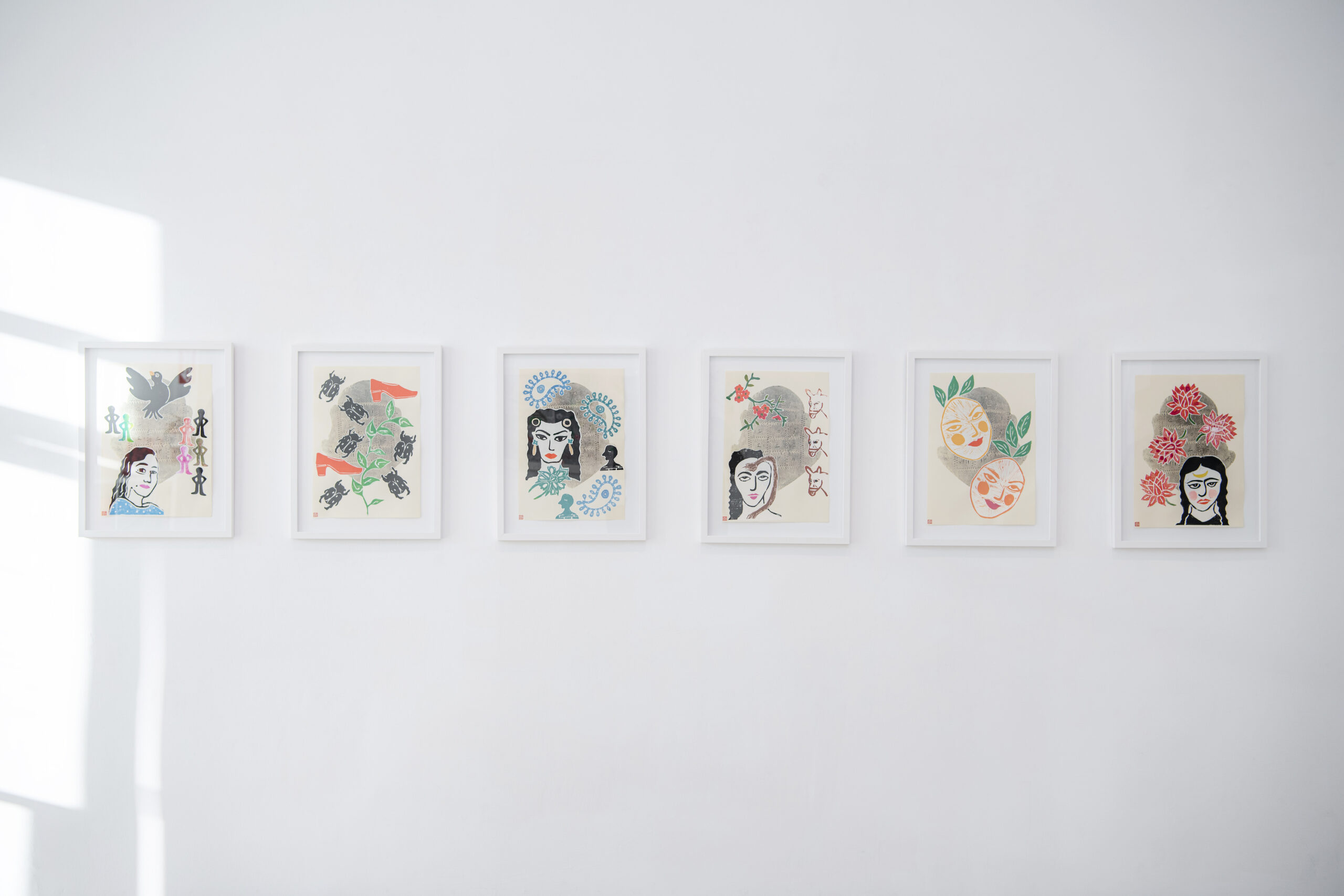 Installation from "Searching for Myself in the Forest of Bewitchment," featuring six linocut print collages on paper by Iranian artist Afsoon